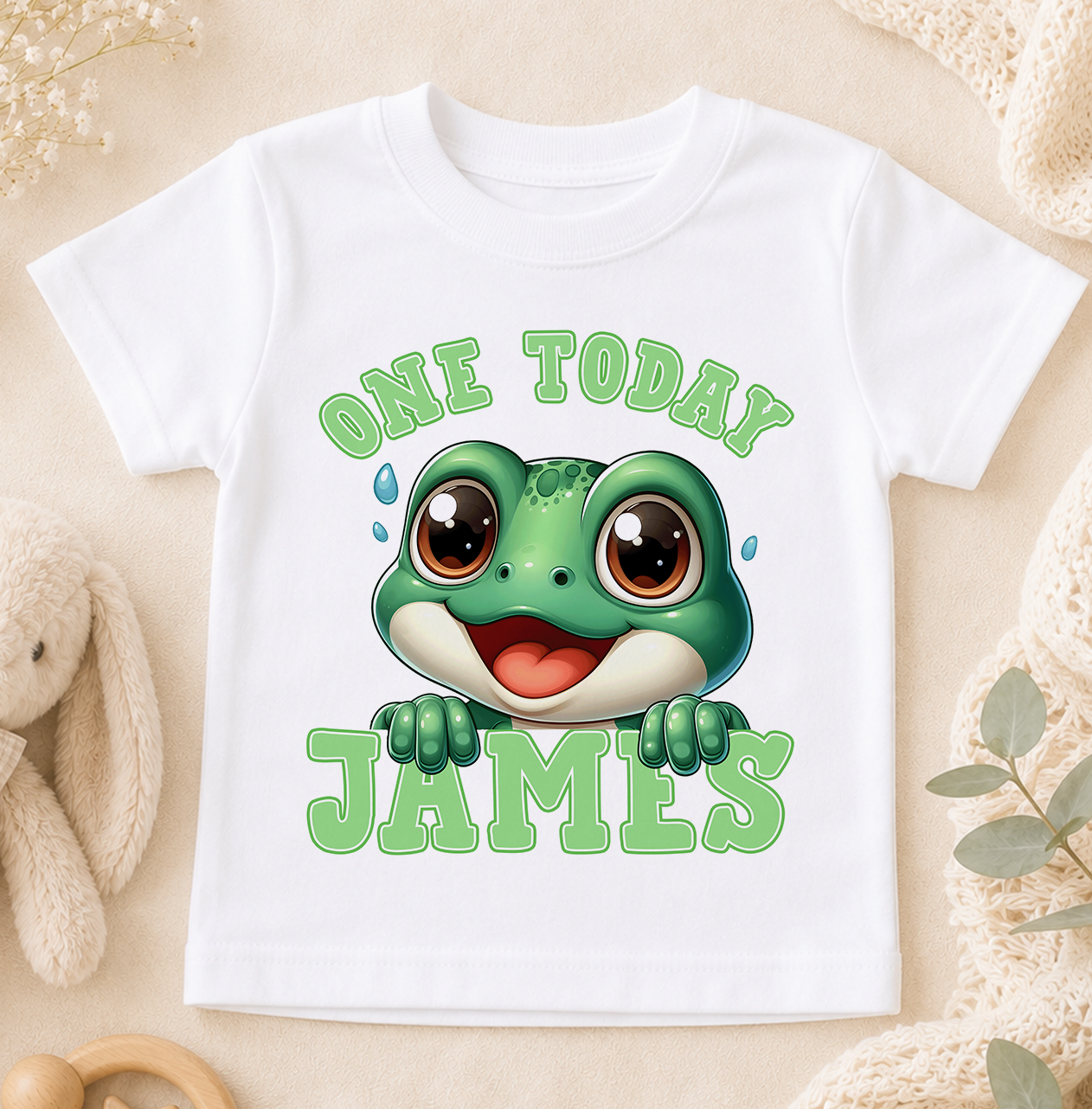White children's birthday t-shirt printed with a cartoon frog design and the personalised text 'One Today James'.