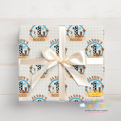 Gift box wrapped in personalised cowboy rodeo wrapping paper with a cowboy hat and bull pattern and white ribbon.
