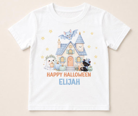 Personalised Halloween t-shirt featuring haunted house, ghost, black cat, bat, pumpkins and custom name on white children's Halloween shirt