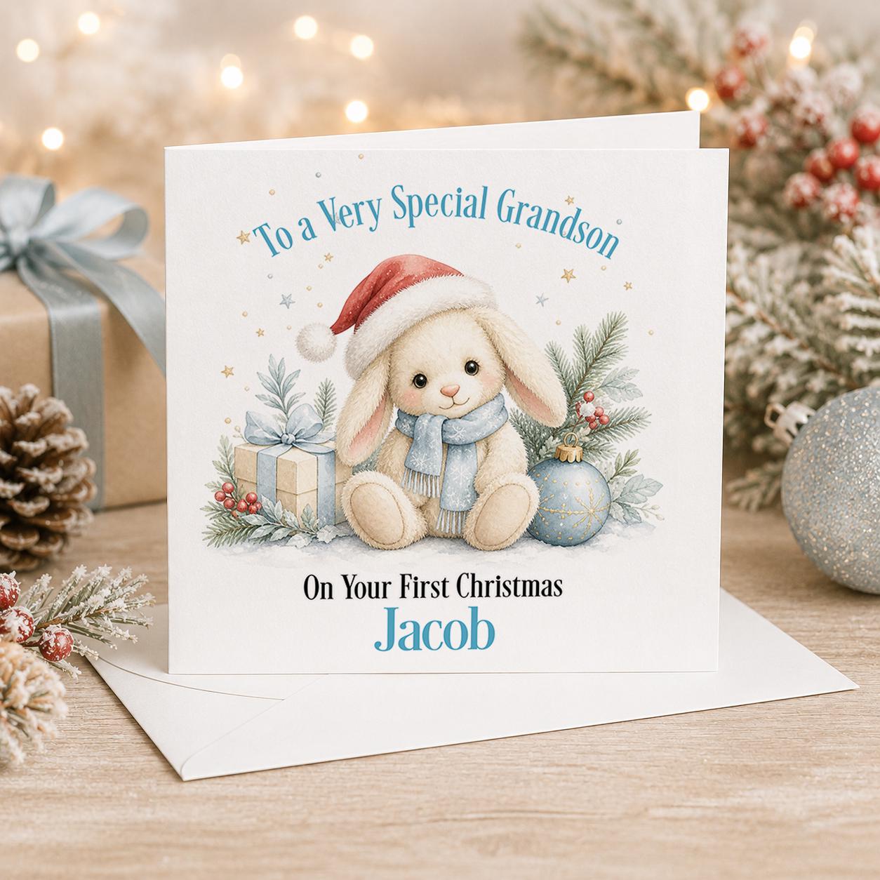 Personalised baby first Christmas card, white 6x6 inch square card printed with a bunny in a Santa hat and baubles with a name