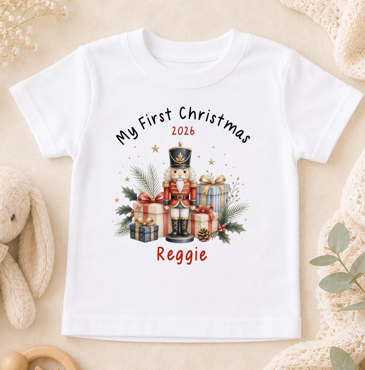 Personalised baby first Christmas t-shirt in white cotton printed with a nutcracker design and baby's name