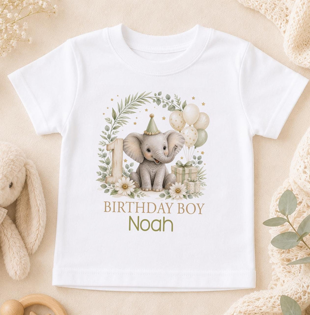 White cotton t-shirt printed with a watercolour elephant in a sage eucalyptus wreath with a number one, with Birthday Boy above a name