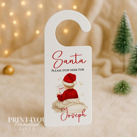 Personalised Santa Door Hanger with custom name, Boy design 1, boy character holding Santa's Nice List on white acrylic