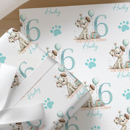 Blue paw print wrapping paper featuring a cartoon puppy and the number six, personalised with a custom name for a nephew.