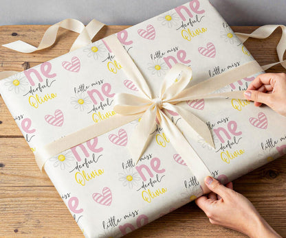 Personalised daisy wrapping paper rolled and shown against a plain background