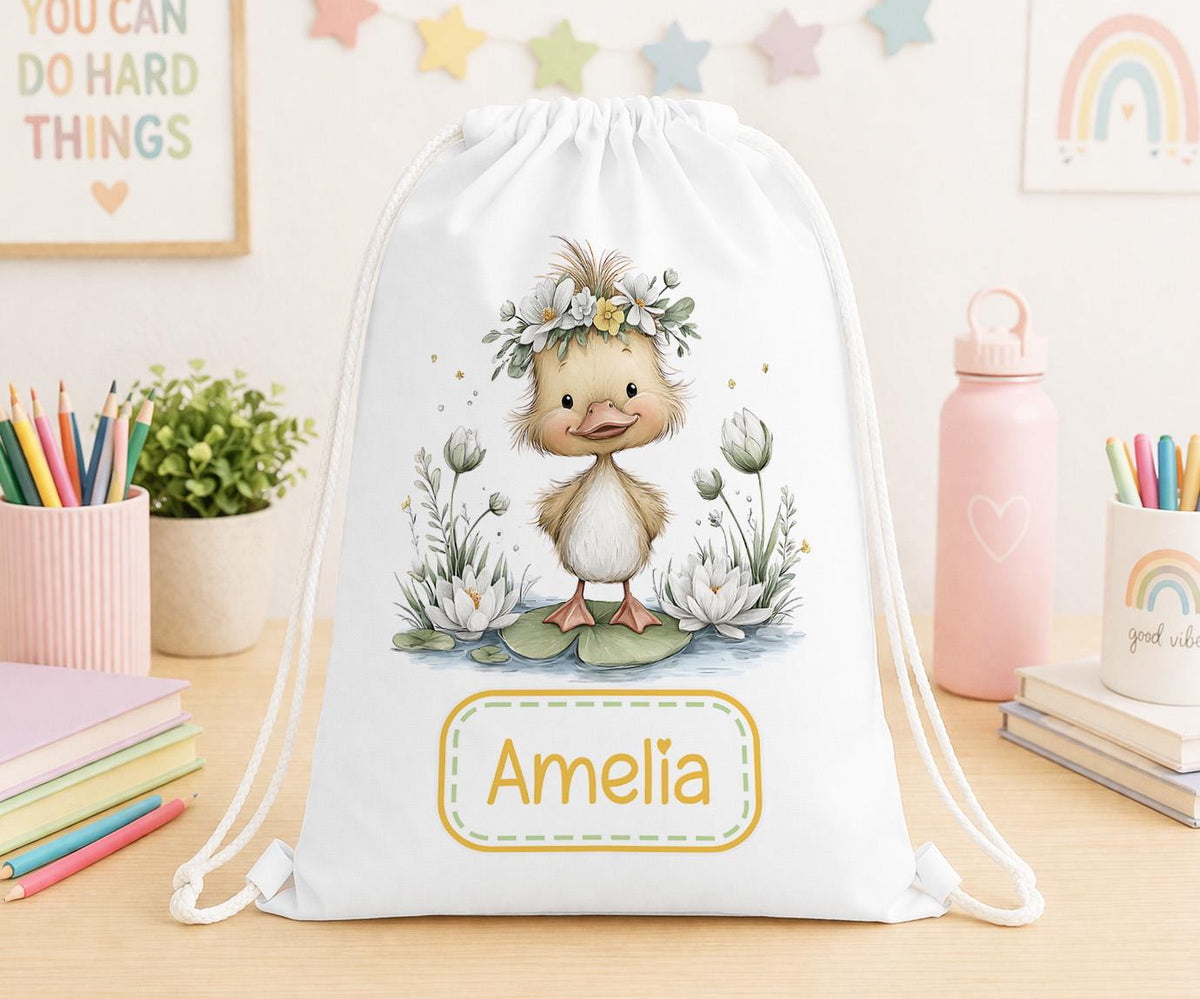 Drawstring nursery bag printed with a duck and floral design, personalised with a child's name across the front