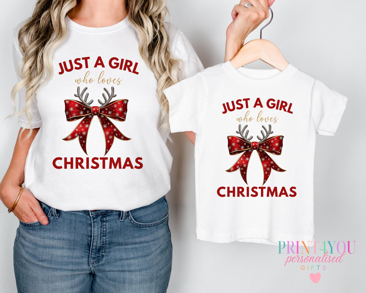 Mum and toddler wearing matching personalised Christmas t-shirts printed with a red bow and antlers design and 'Just a girl who loves Christmas'