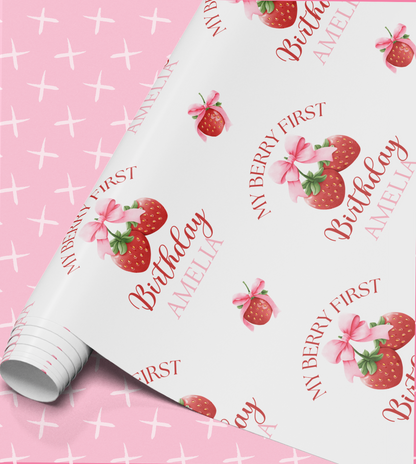 a pink background with a repeating pattern of strawberries and bows. The pattern includes the text "My Berry First" and "Amelia" written around the strawberries and bows.