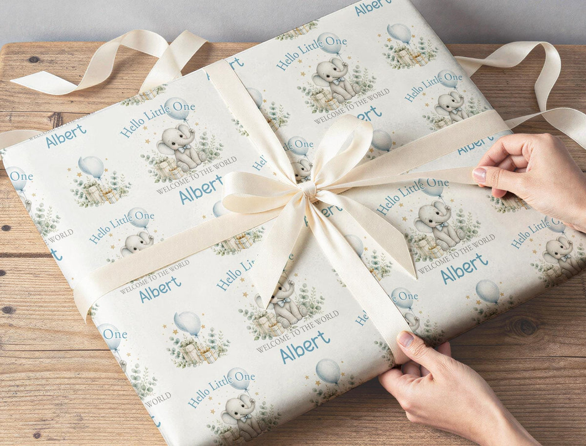 New baby gift wrapped in personalised Hello Little One elephant wrapping paper with custom name