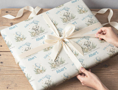 New baby gift wrapped in personalised Hello Little One elephant wrapping paper with custom name