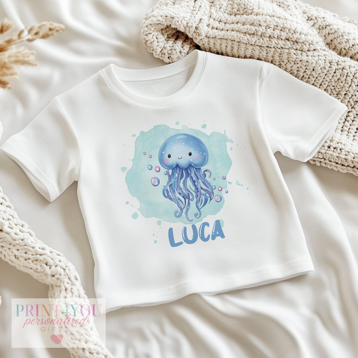 Personalised jellyfish baby sleepsuit in soft cotton with popper fastenings, printed with baby's name.
