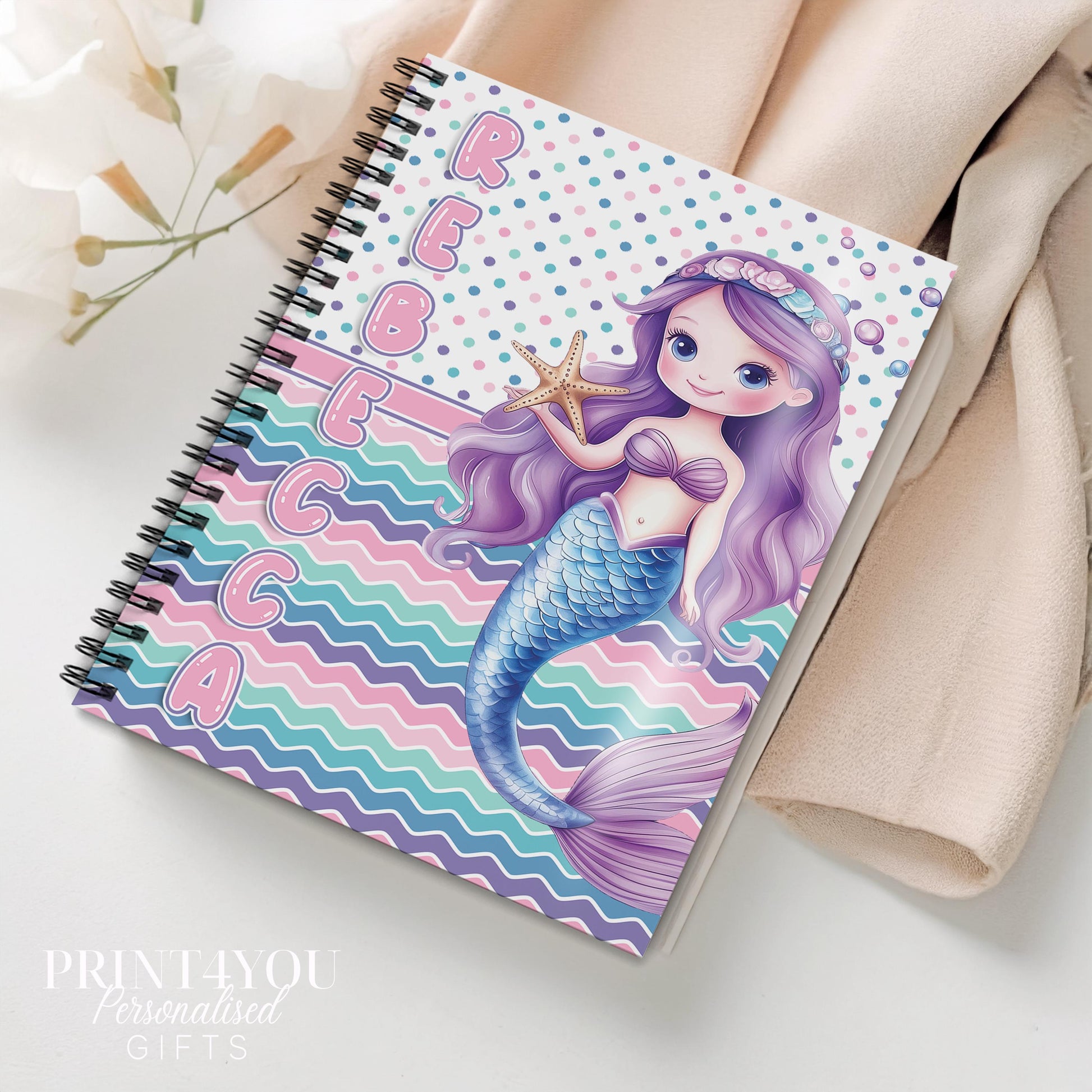 Personalised A5 mermaid tail notebook with custom name printed on the front cover, pastel rainbow spiral notepad