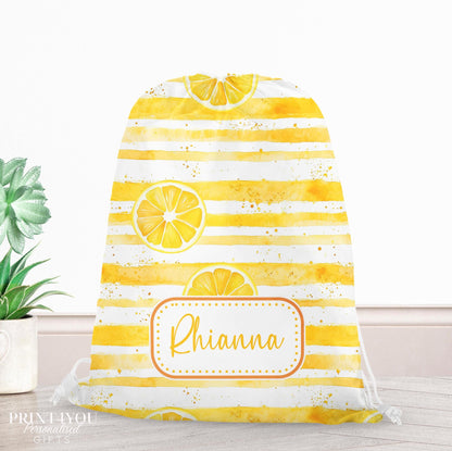 Yellow watercolour-striped drawstring PE bag printed with a lemon slice design, personalised with a child's name across the front