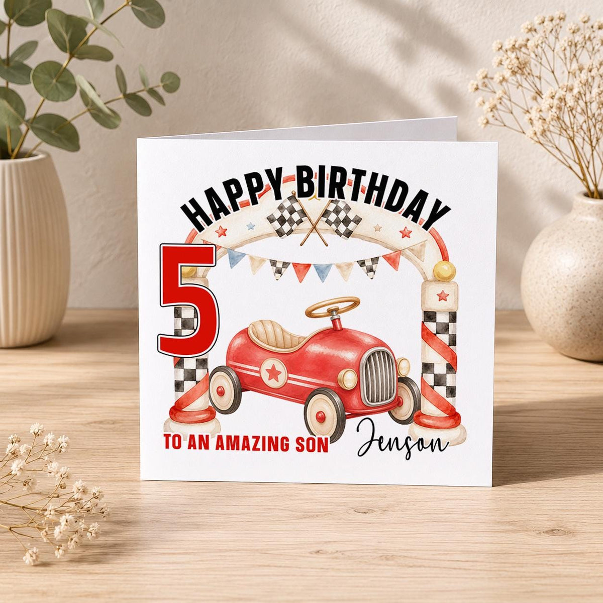 Square birthday card reading Happy Birthday with a red vintage pedal car, chequered racing flags and bunting, personalised To an Amazing Son Jenson 5.