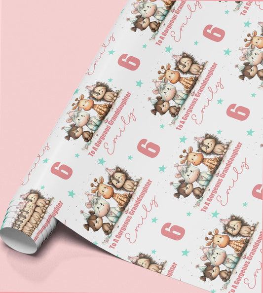 Roll of personalised birthday wrapping paper printed with cartoon dogs, horses, giraffes and elephants, with the name Emily and 'To A Gorgeous Granddaughter' printed across it