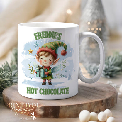 White ceramic mug personalised with a custom name, printed with a cheerful Elf Hot Chocolate Christmas design