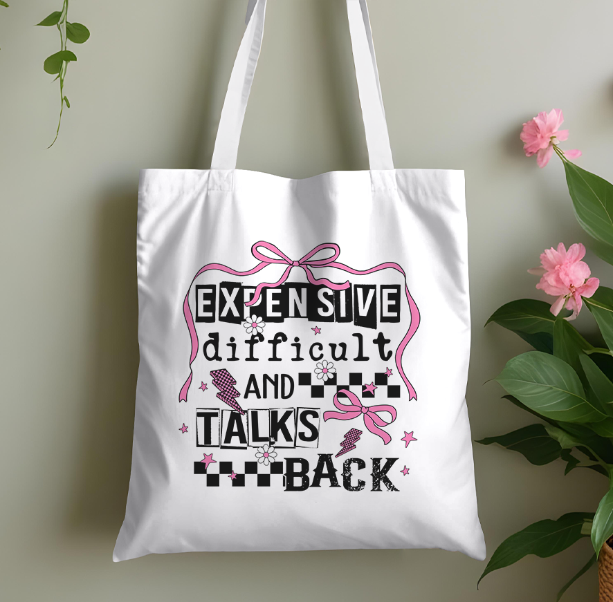 Cotton tote bag with a pink bow design and a witty slogan print, a fun novelty shopper for her.