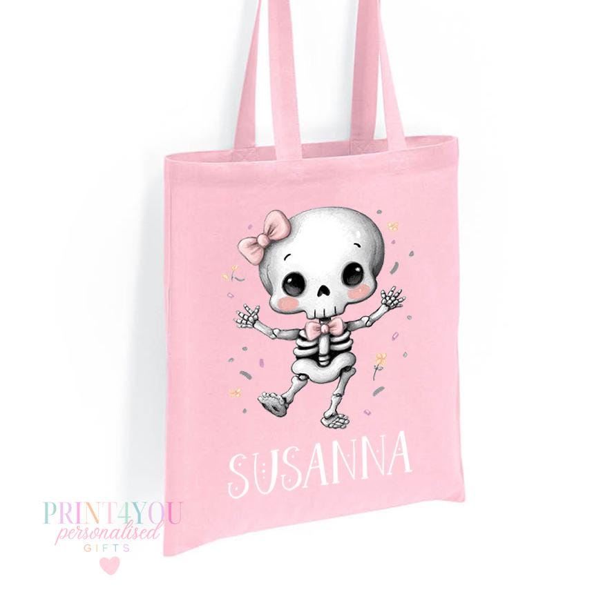 Close-up of the personalised skeleton and pink bow print on the Halloween tote bag showing the custom name detail