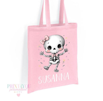 Close-up of the personalised skeleton and pink bow print on the Halloween tote bag showing the custom name detail