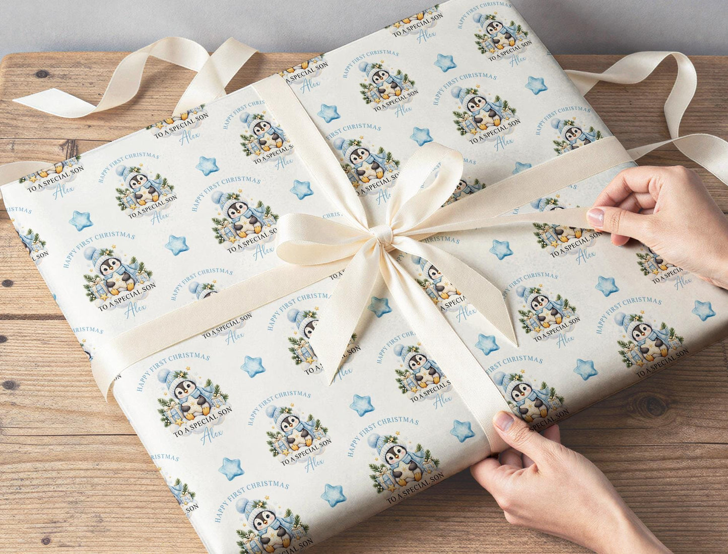 Gift wrapped in the personalised penguin baby first Christmas wrapping paper with a ribbon
