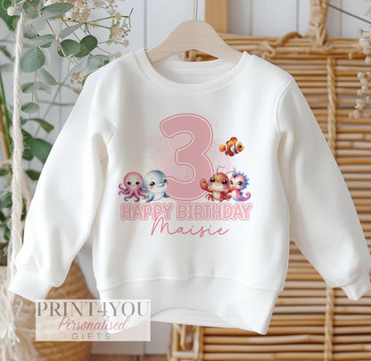 Personalised white sweatshirt for children with pink under the sea animals design, customised with name and birthday number