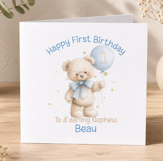 White 1st birthday card for a baby boy featuring a teddy bear holding a blue balloon