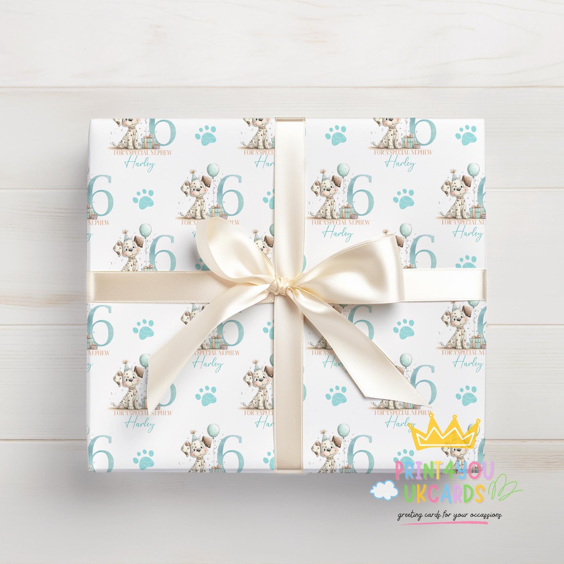 Personalised puppy wrapping paper laid flat, showing the full blue paw print pattern with custom name.
