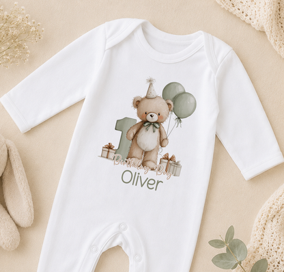 White baby onesie printed with a teddy bear and balloons design, personalised with the sample name 'Olivier'.