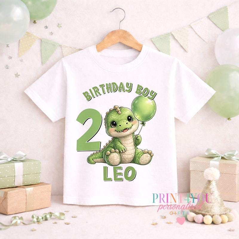 Close-up of the personalised dinosaur birthday jumper print showing the custom name and age detail.