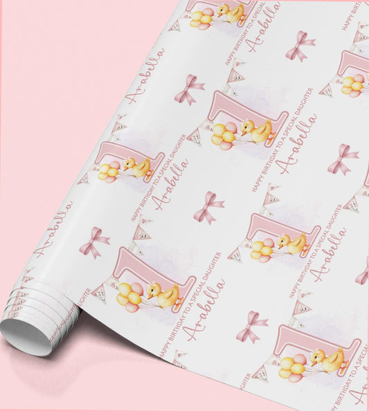 a roll of wrapping paper with a repeating pattern of a yellow duck holding balloons and the name "Abella" written on it.