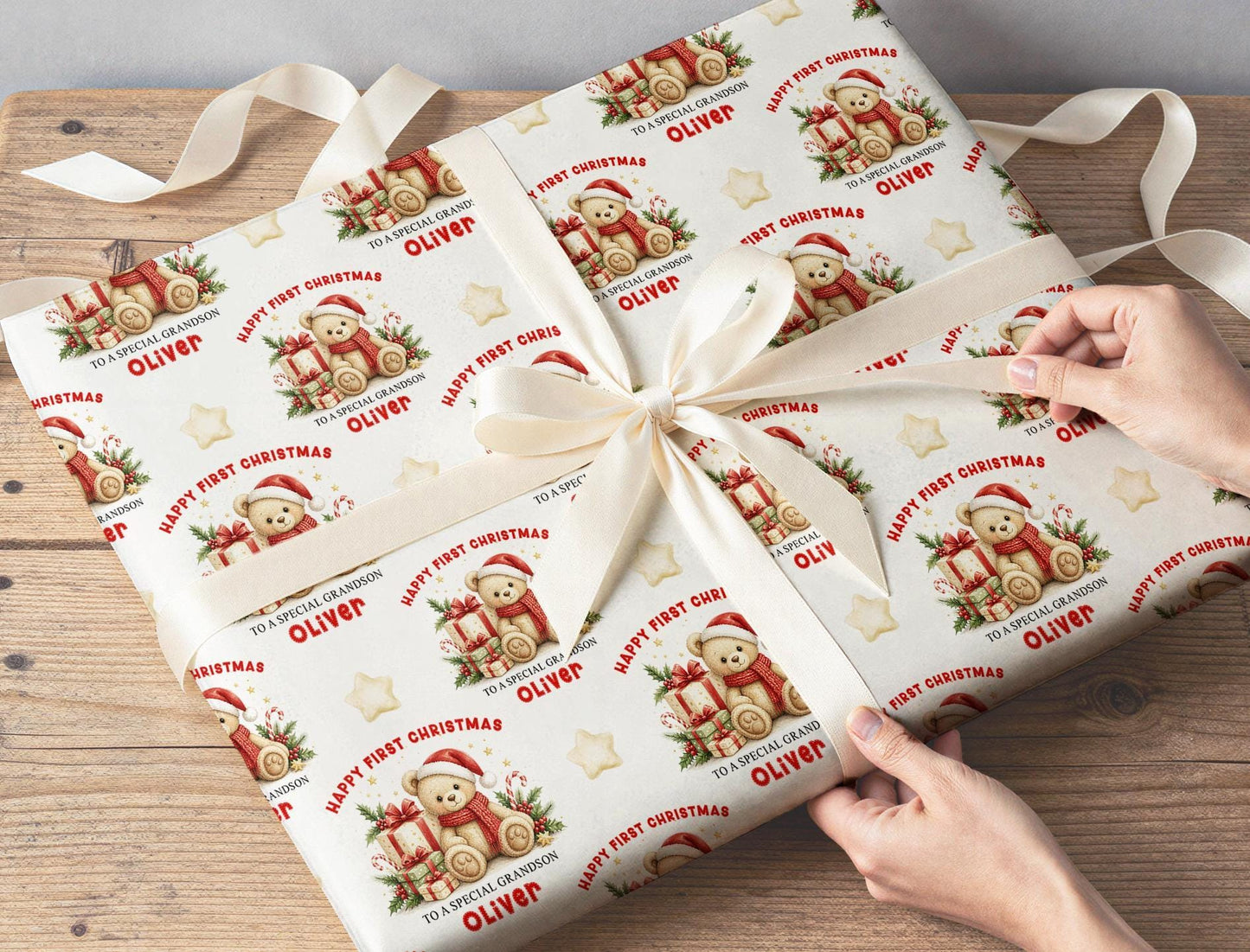 A gift wrapped in the personalised teddy bear first Christmas paper and tied with cream ribbon