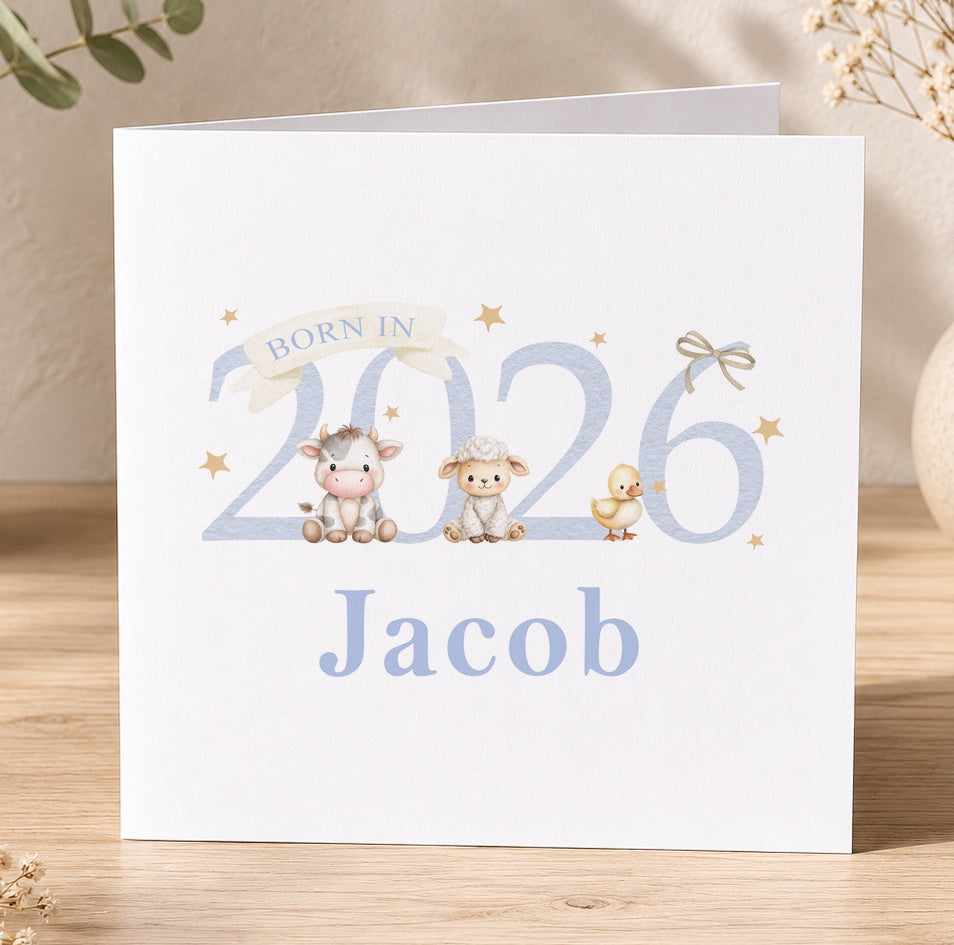 Square newborn greeting card featuring an illustrated cow, sheep and duck with the personalised text 'Born in 2026, Jacob'.