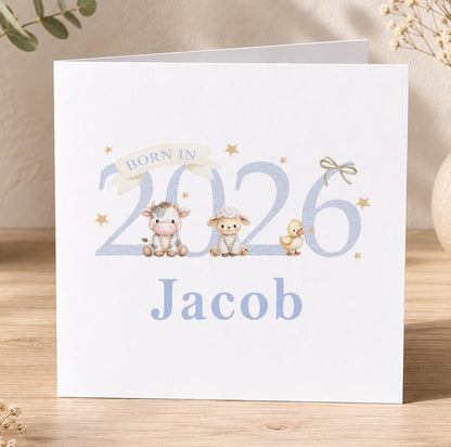 Square newborn greeting card featuring an illustrated cow, sheep and duck with the personalised text 'Born in 2026, Jacob'.