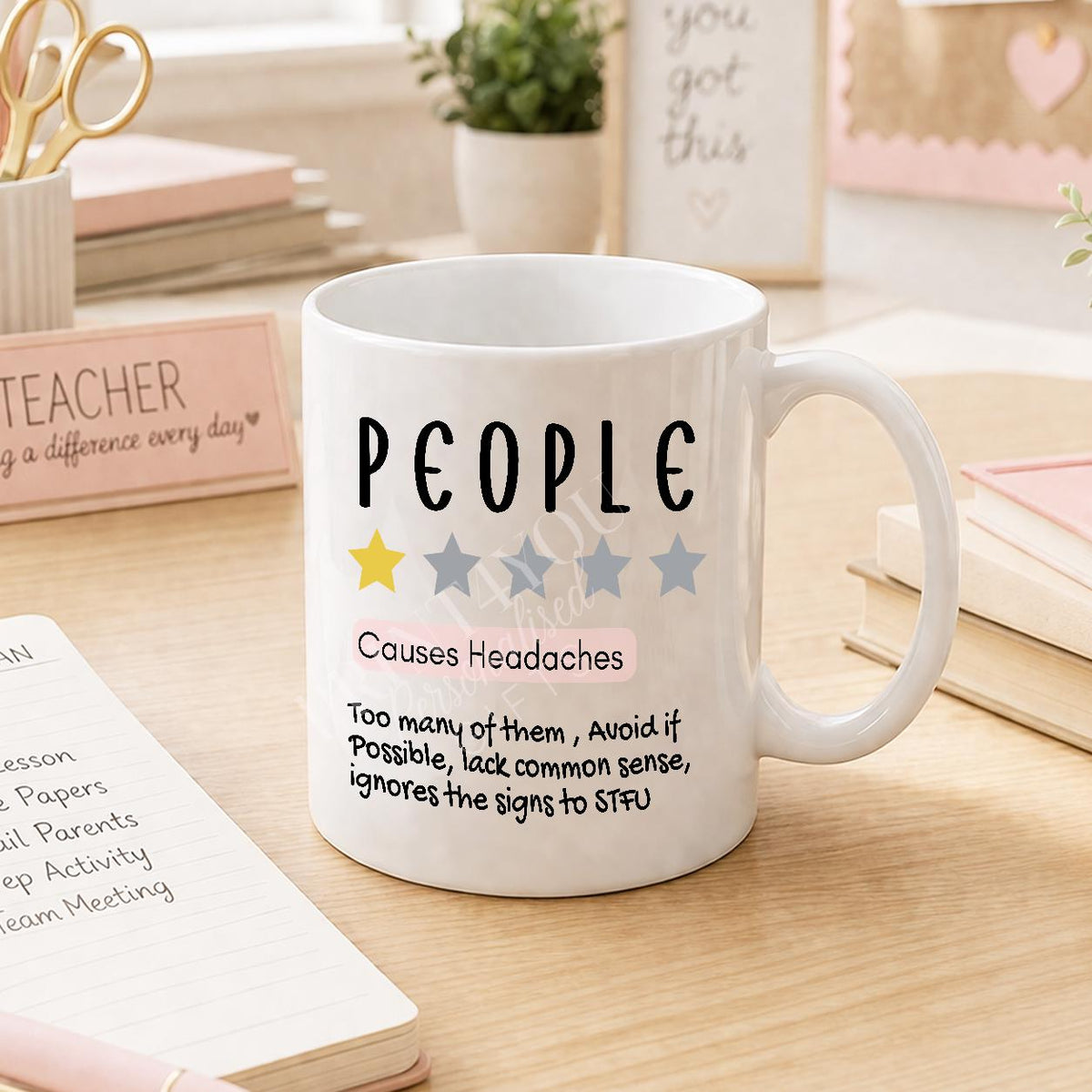 Close-up of the 'People Cause Headaches' design printed on the mug