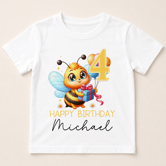 A white t-shirt with a cartoon image of a bee holding balloons and a gift, along with the text "Happy Birthday Michael" printed on it.