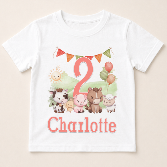 A white t-shirt with a cartoon image of farm animals, including a horse, cow, pig, and sheep, along with a number 2 and the name "Charlotte" printed on it.