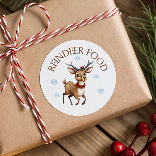 A brown gift box with a white label featuring a cartoon reindeer wearing a red scarf and antlers, surrounded by snowflakes.
