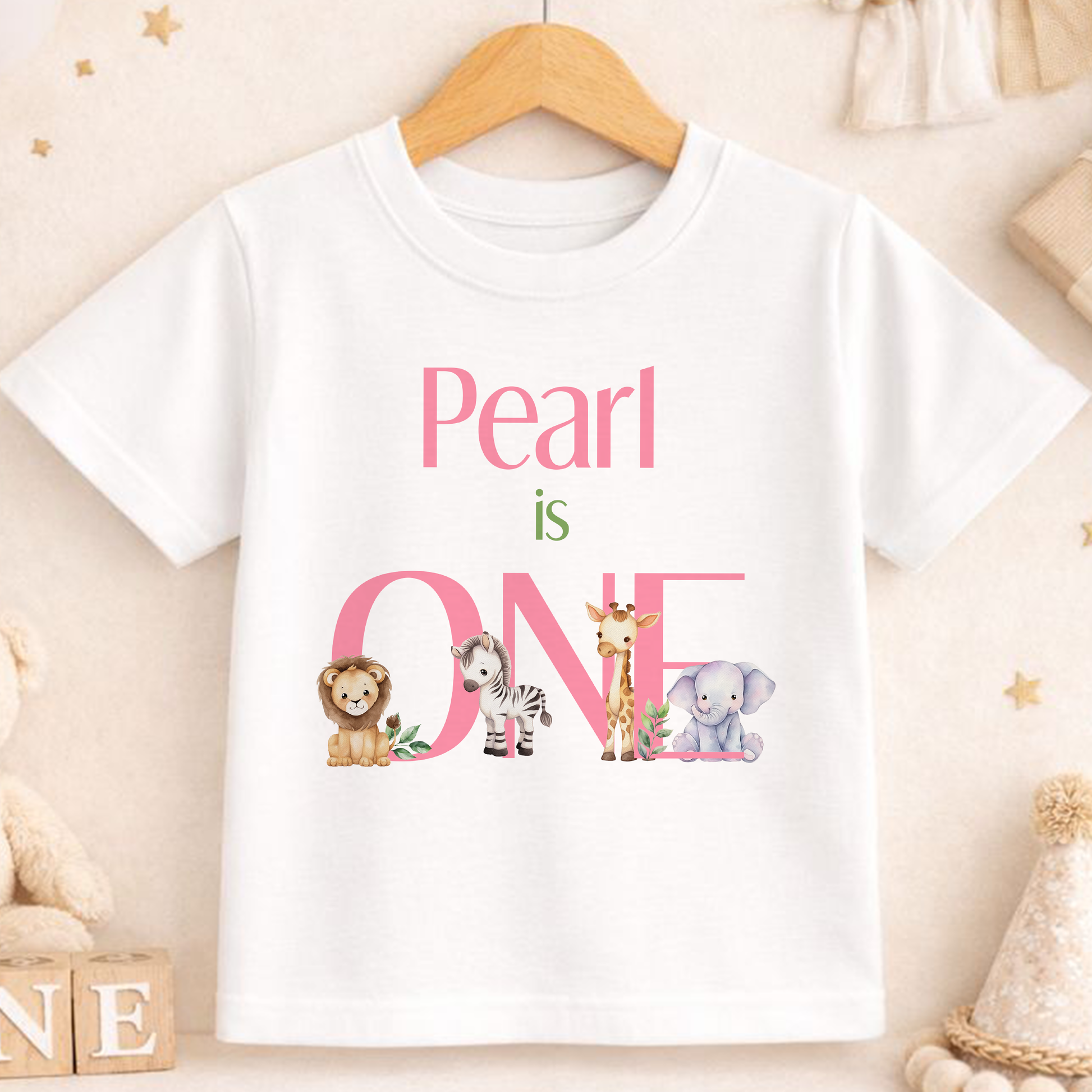 Personalised safari first birthday t-shirt with pink 'is ONE' text and safari animal print.