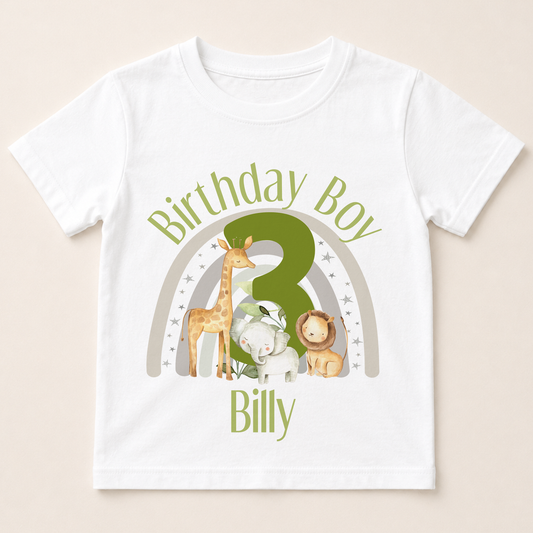 A white t-shirt with a graphic design featuring a giraffe, lion, and elephant, along with the text "Birthday Boy Billy" and a number 3.