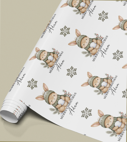 Close-up of the personalised bunny rabbit Christmas gift wrap pattern showing the custom name detail