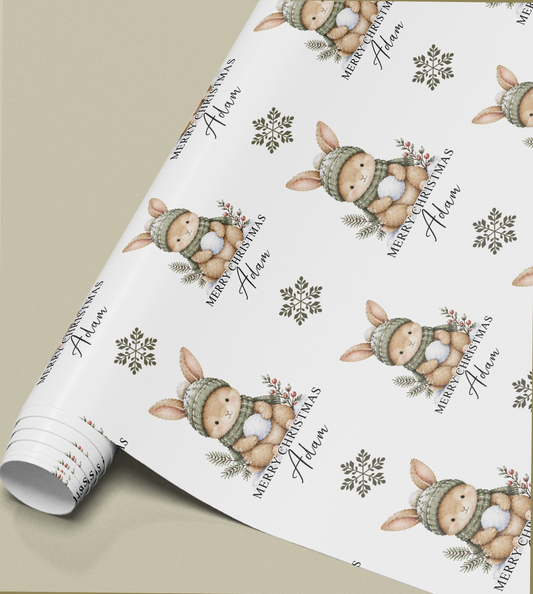 Close-up of the personalised bunny rabbit Christmas gift wrap pattern showing the custom name detail
