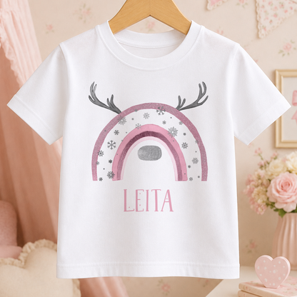 A white t-shirt with a pink and silver design featuring a rainbow and antlers, along with the name "LEITA" printed on it.
