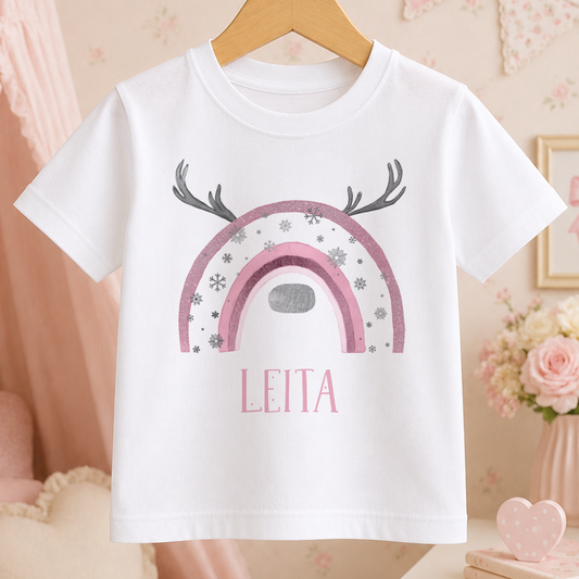 A white t-shirt with a pink and silver design featuring a rainbow and antlers, along with the name "LEITA" printed on it.