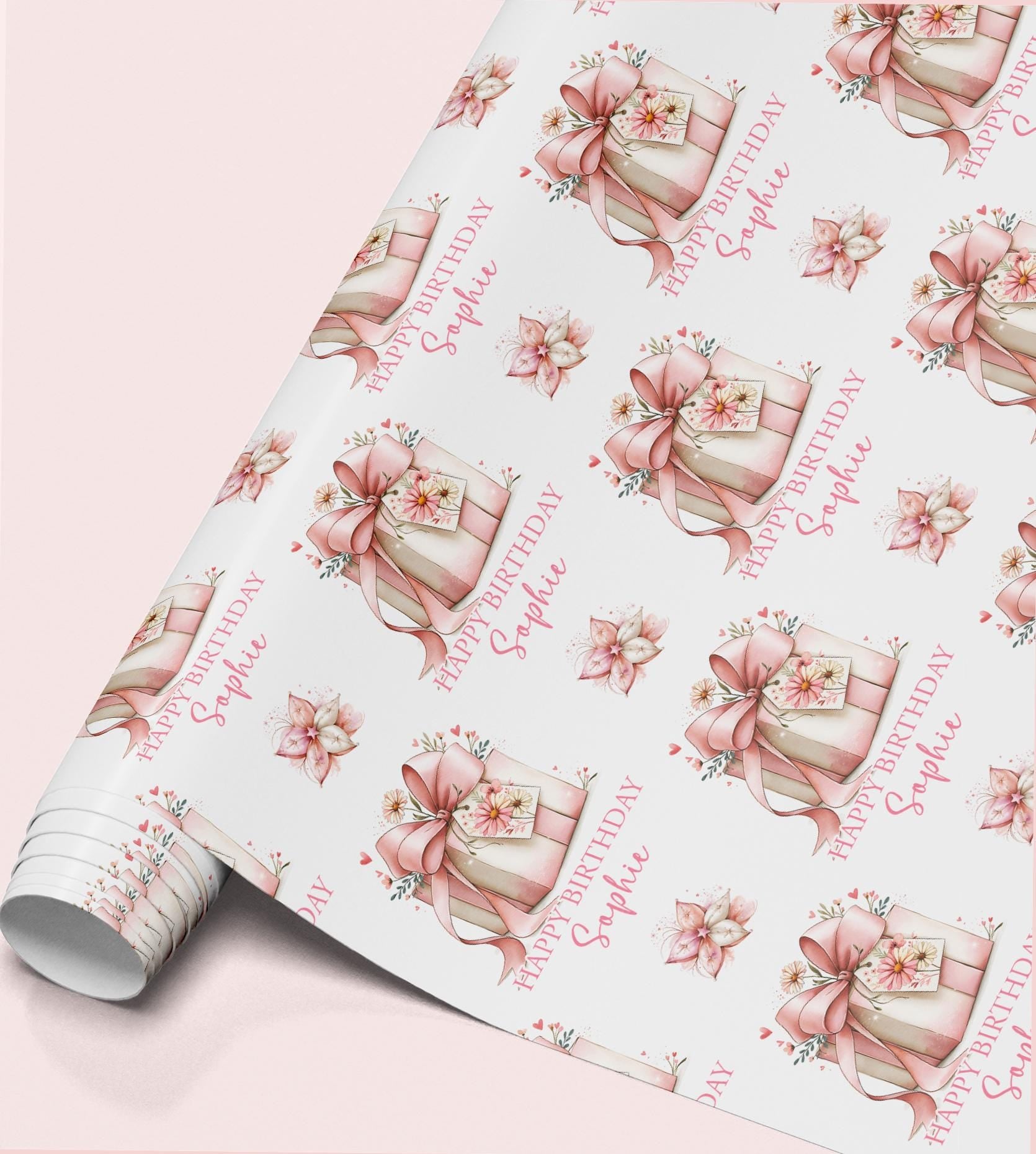 Personalised birthday wrapping paper featuring a pink gift box with floral ribbon, custom name and elegant pink flowers.