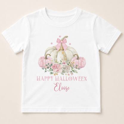 A white t-shirt with a graphic design featuring a floral arrangement of pumpkins and a bow, along with the text "Happy Halloween Eloise".