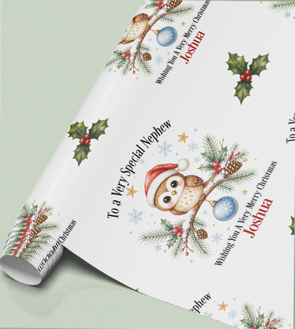 Rolled sheet of personalised owl Christmas wrapping paper printed with a name and relation