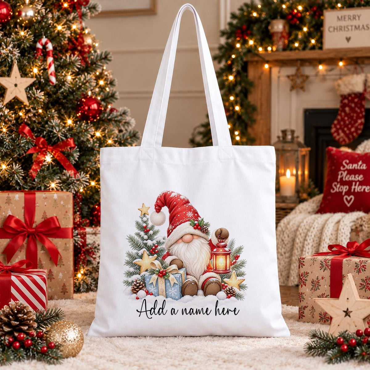 White cotton tote bag printed with a red-hatted Christmas gnome holding a lantern with snowy pine and gold stars, above a name.