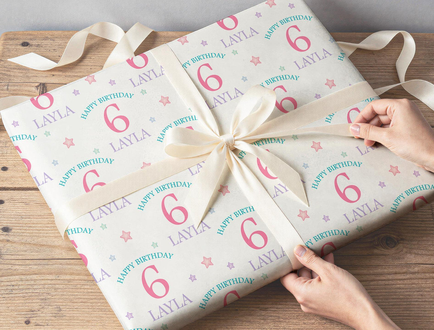 Gift wrapped in the personalised pastel stars wrapping paper, tied with ribbon.