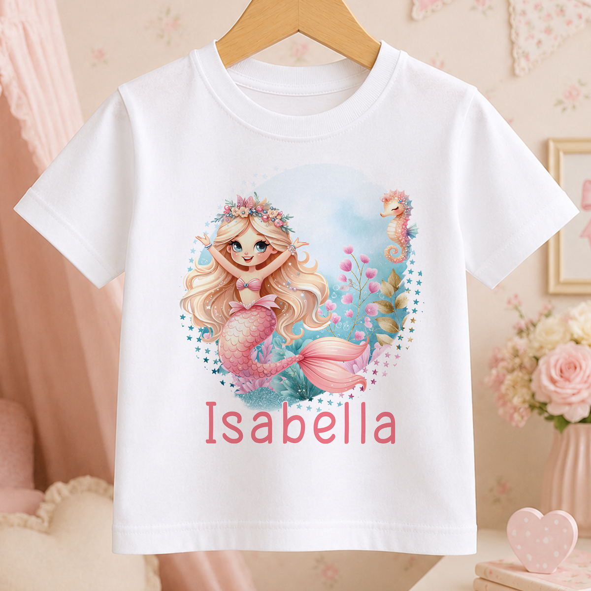 A white t-shirt with a mermaid design and the name "Isabella" printed on it.