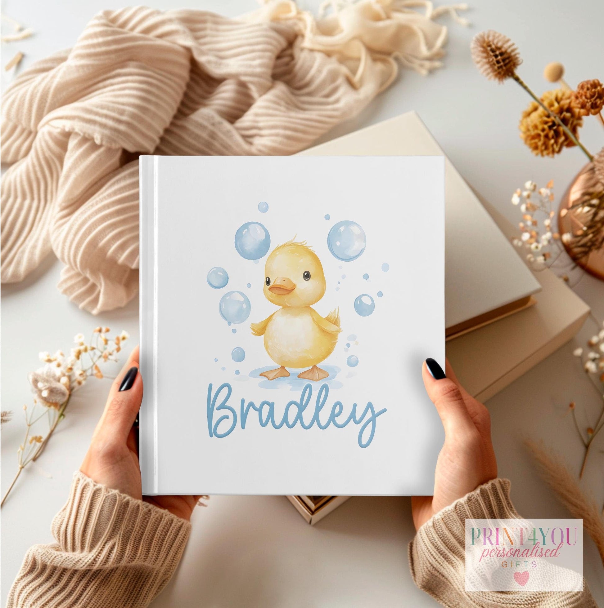 Personalised first birthday photo album with rubber duck design and custom name on the cover